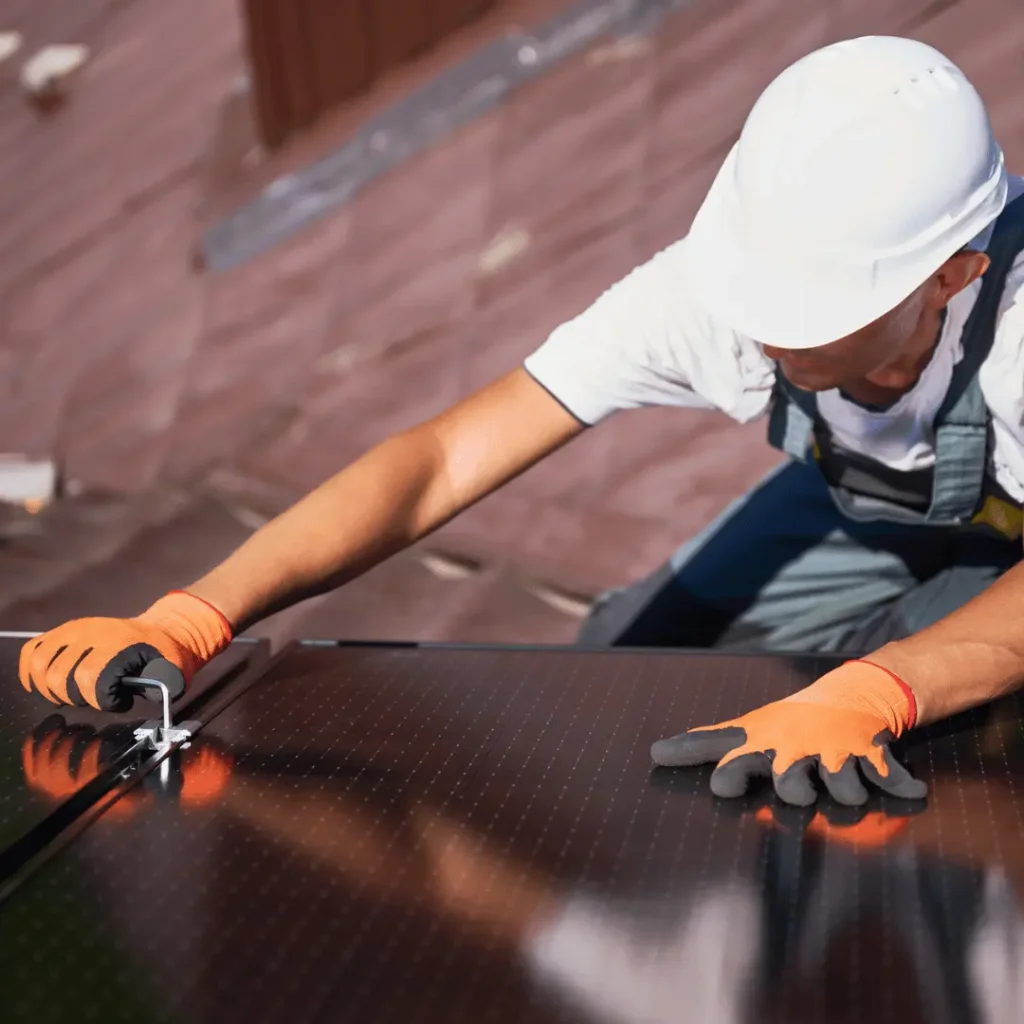 Man Installing or Repairing Black on Black Solar Panels on Roof