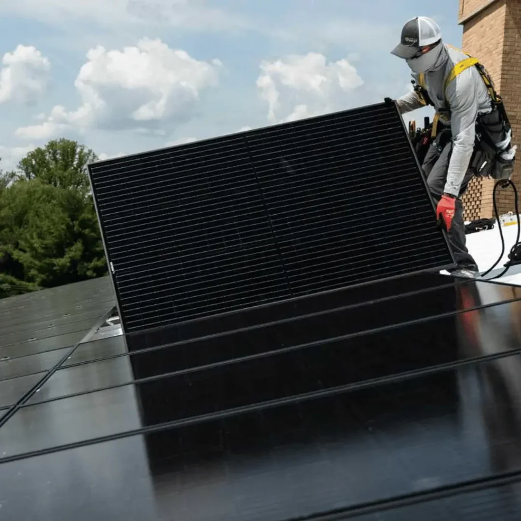 Man Installing Black on Black Solar Panels on Roof